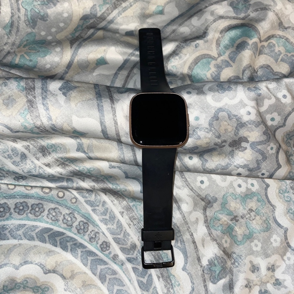 Fitbit Versa 2 watch in rose gold with three extra bands.